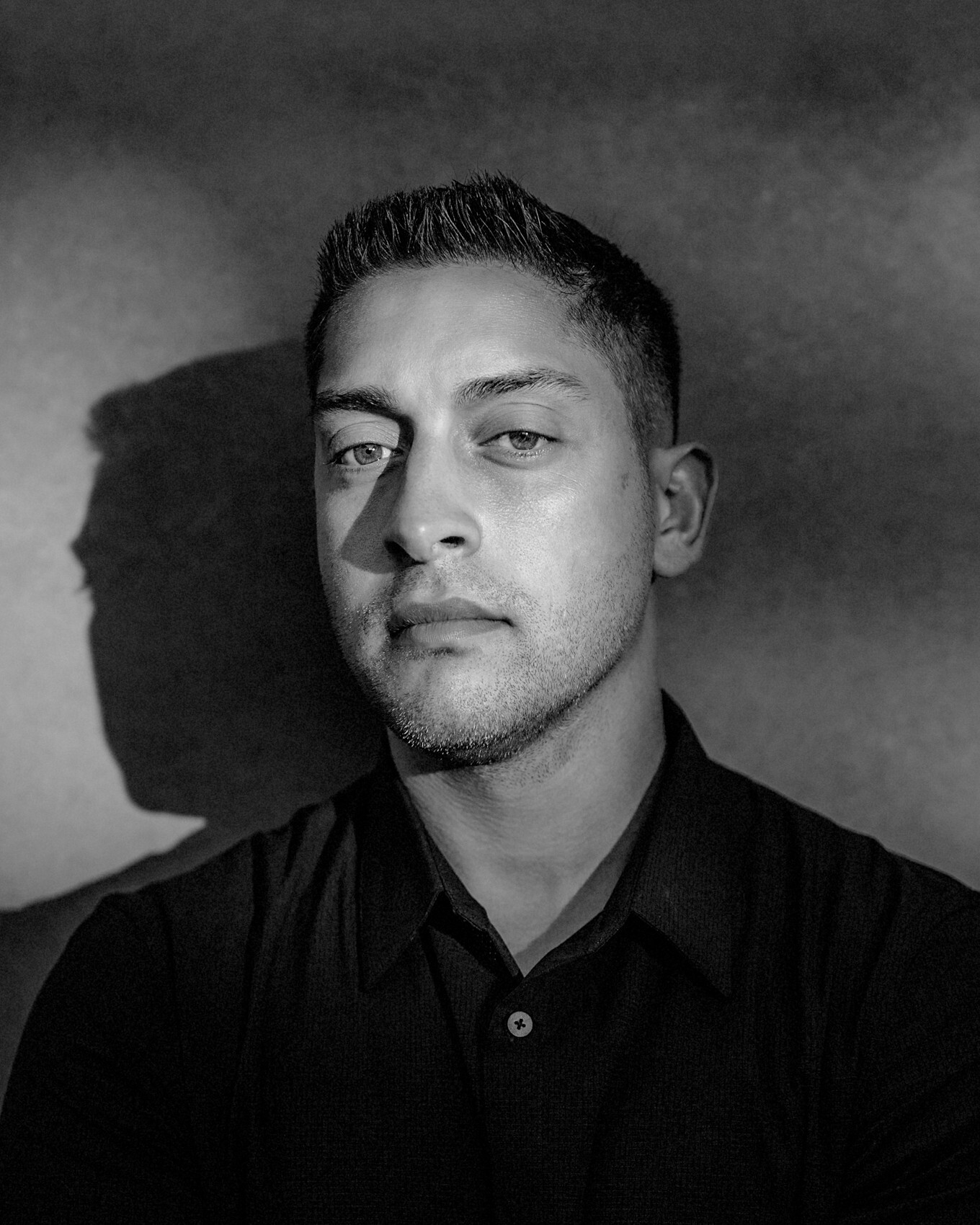 Daniel Hallak, PhD — black-and-white studio portrait, looking directly at the camera.